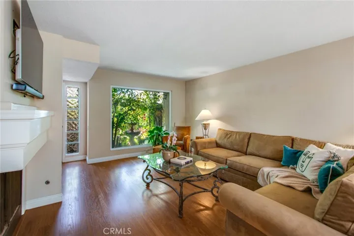 Living room area including gas fireplace and large window to front patio.