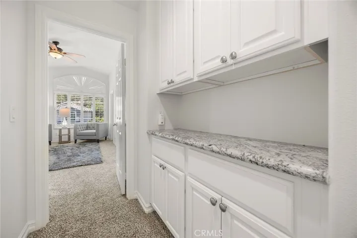 Generous size linen cabinets with granite countertop
