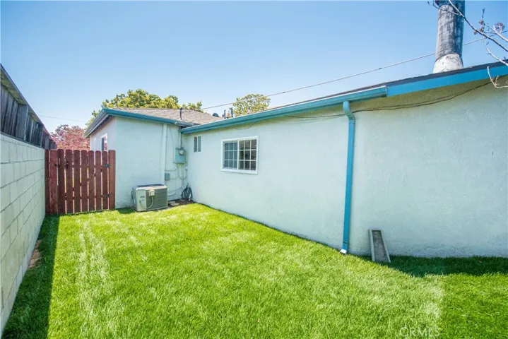 Backyard grassy area to side of home