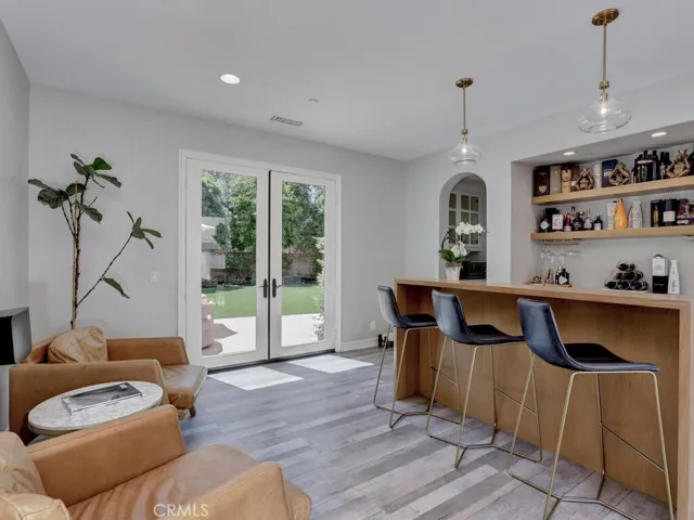 The wine/beverage room with a great serving bar and french doors opening to the lawn.