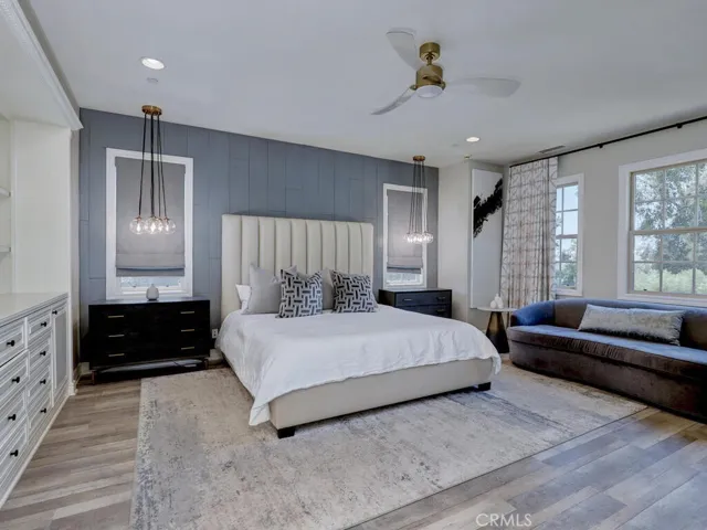 Upstairs, the primary suite includs built-ins, views to the pretty yard and a juliet balcony opening to the interior courtyard.