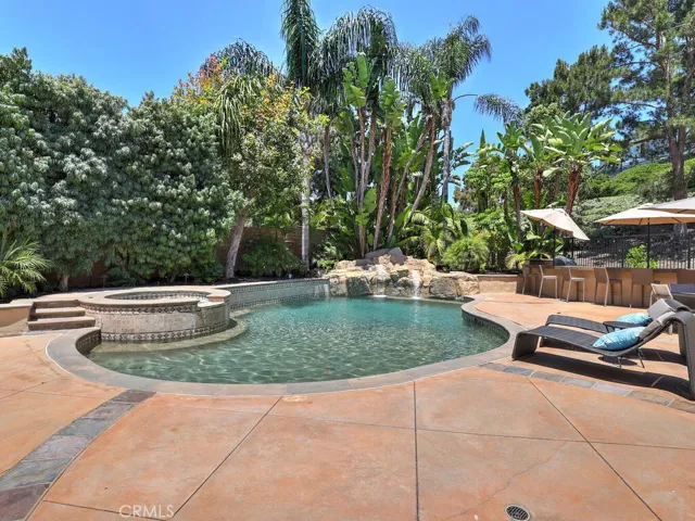 Mature foliage serves as the perfect backdrop for the pool. Also, although it is only a residential street behind (sitting well below the lot) the foliage minimizes any potential noise from the street.
