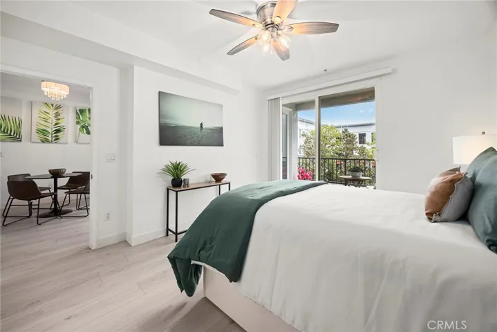 The primary bedroom is a light and airy escape. It is a calm and restful space.