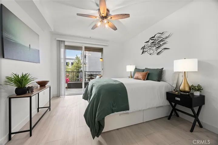 This view of the primary bedroom shows direct access to the balcony.