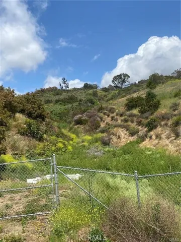 The land is behind the fence shown going up the slope.