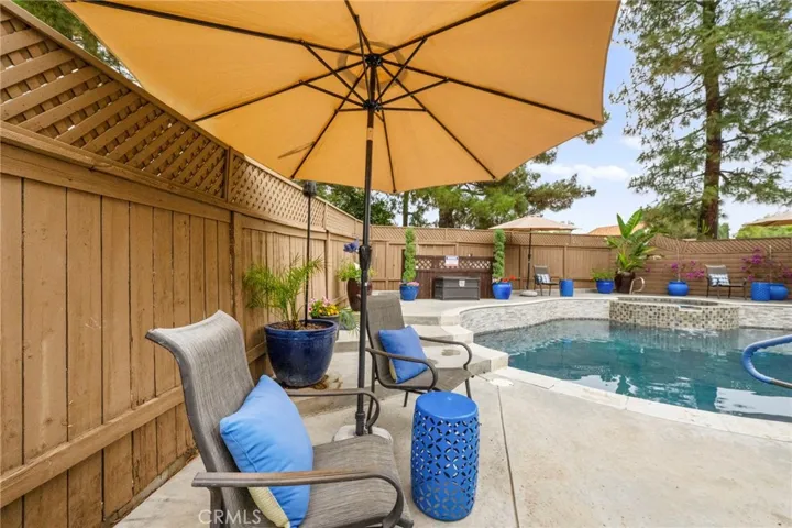 The pool features stacked stone