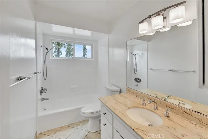 Granite counter top in the bathroom.  Newer vinyl window
