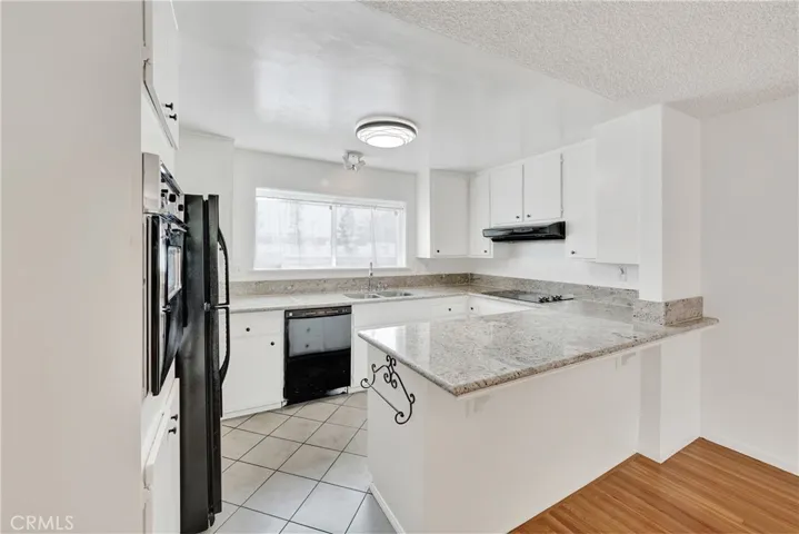 dishwasher, stove top and ventilation hood.