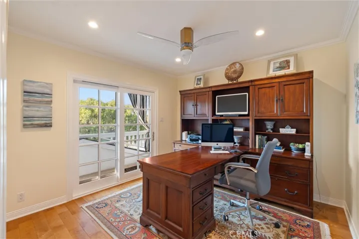 Third bedroom with a balcony view currently used as an office.