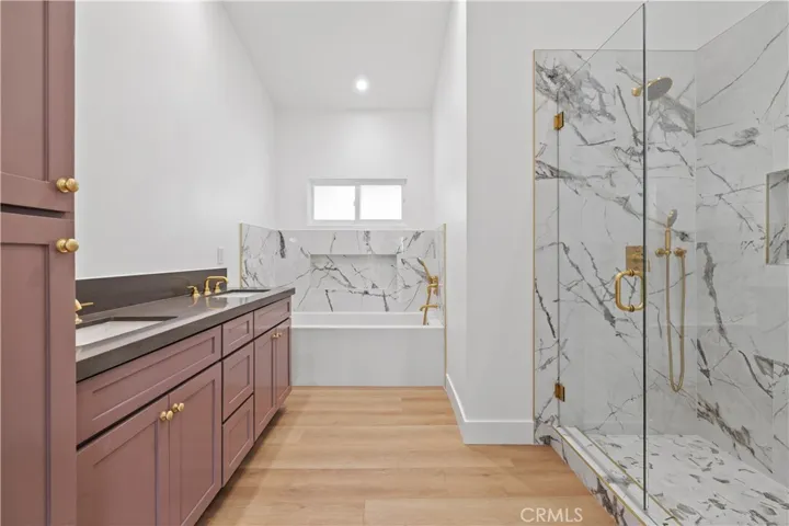 Dual sinks with large soaking tub and walk-in shower.