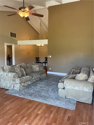 Living Space complete with wood burning fireplace and cathedral ceilings.