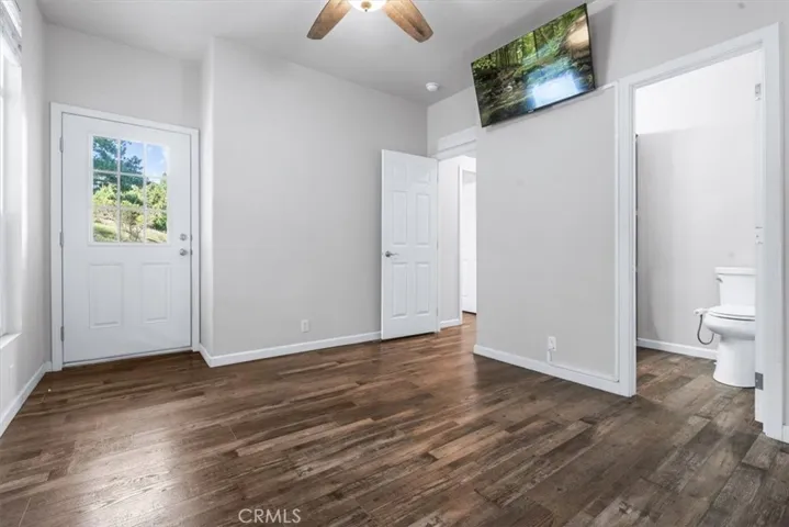 Primary with built in TV, ceiing fan and door to yard.
