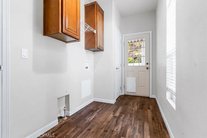 Huge laundry room with cabinets and a pantry, plenty of room to add more shelves.