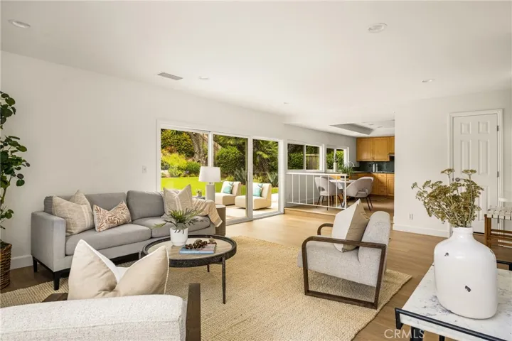 The large family room is open to the remodeled kitchen, with windows to the backyard.