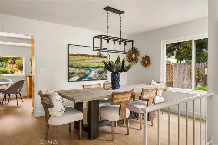 The formal living room is open to the dining room, with the kitchen just beyond.
