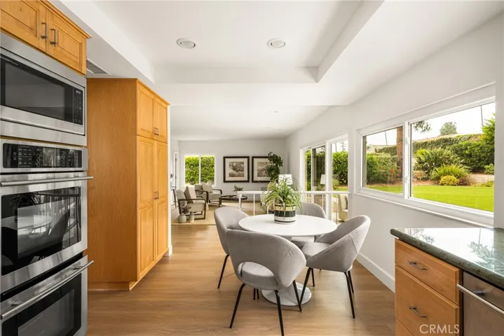 Kitchen features double ovens (including convection) plus a microwave oven, and a view into the family room.