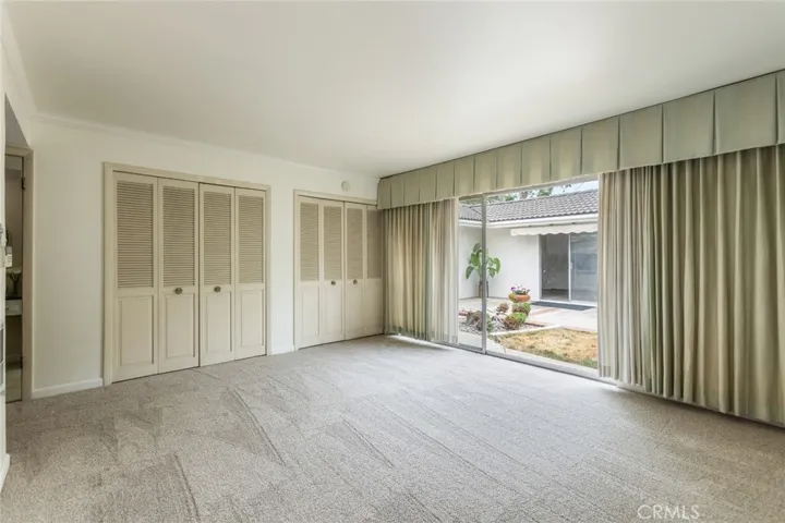 Sliding glass doors from the primary bedroom to the backyard