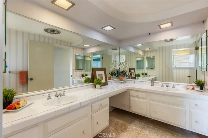 Terrazzo flooring and mirrored double vanity