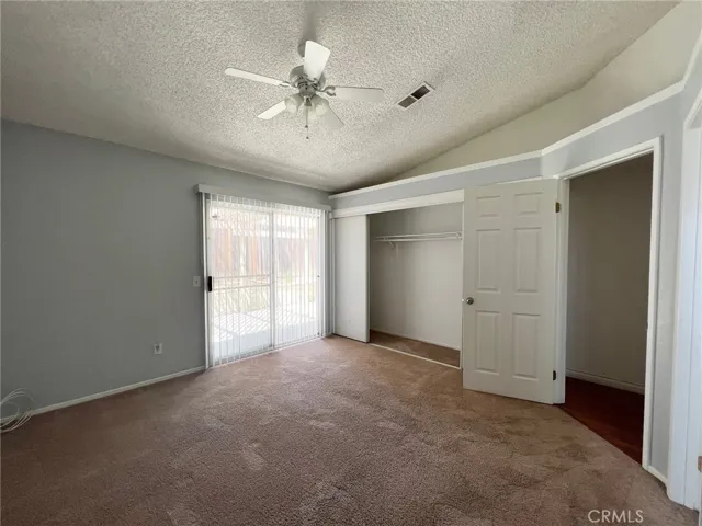 Bedroom 2 with sliding door access to rear yard.