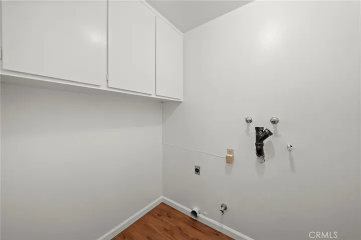 Inside laundry room with storage