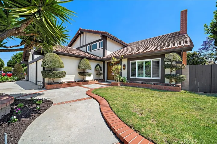 Offering a rare combination of style, space, and functionality, this home features an extra-wide driveway with brick ribbon walkway, raised planters, and a charming double-door entry.