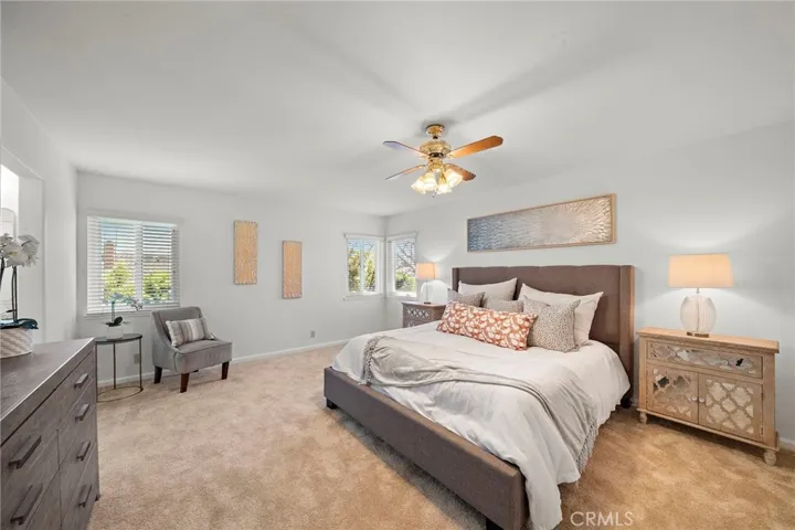 Huge primary suite with ceiling fan and center lighting.