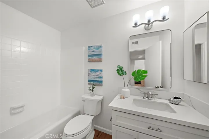 Updated downstairs bathroom with new vanity, lights, mirror and toilet