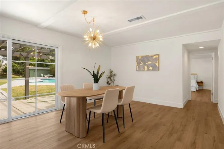 dining overlooks pool and spacious yard
