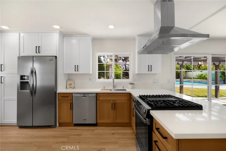 stainless appliances, island hood, overlooks dining room and pool.