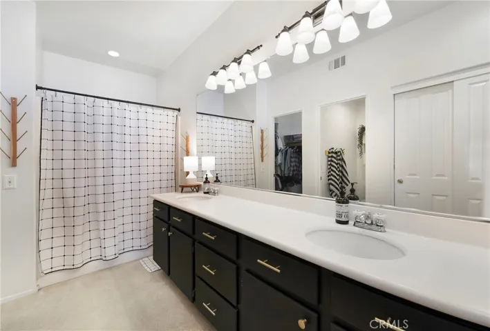 Dual vanities, tub and shower as well as walk in closet and secondary closet.