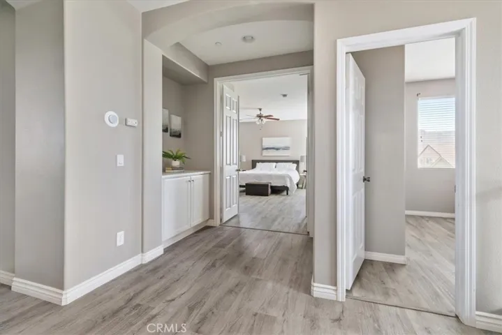 Framed by soft archways and elegant double doors, the entry to the expansive primary suite offers a grand and inviting feel. Just steps away, you'll find one of the five upstairs bedrooms—perfect for guests, a nursery, or a home office.