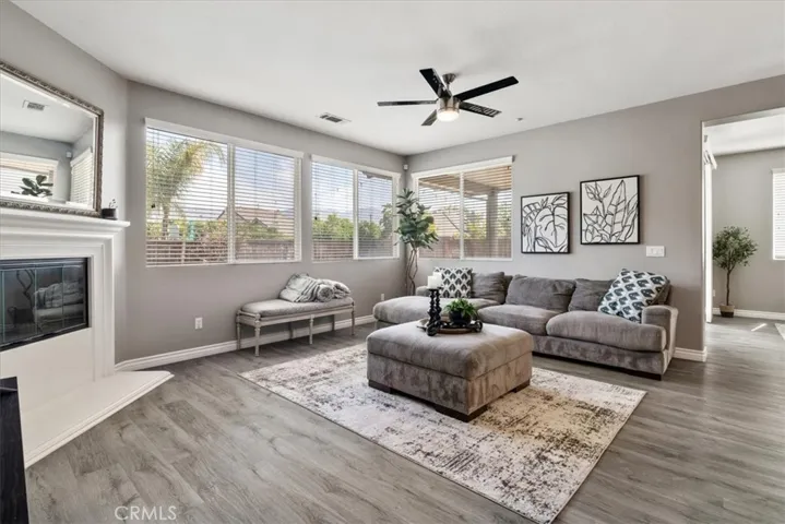 Spacious great room with plenty of natural light — perfect for entertaining or relaxing in style!