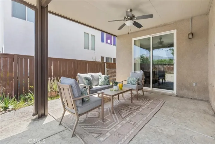 Enjoy year-round outdoor living under the spacious covered patio, complete with a ceiling fan for added comfort. Whether you're sipping your morning coffee or hosting evening gatherings, this inviting space offers a perfect extension of your indoor living area with easy access through sliding glass doors.