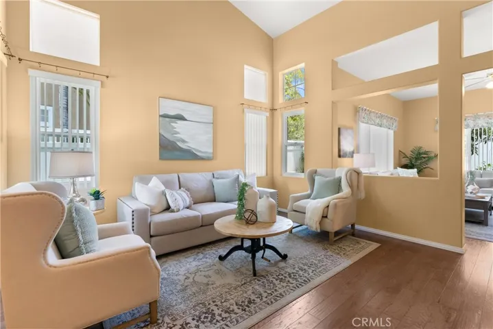 Welcoming view into the formal living room with vaulted ceilings.