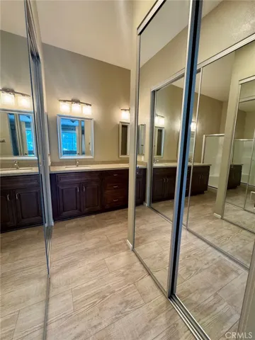 Two mirrored closets in primary bathroom