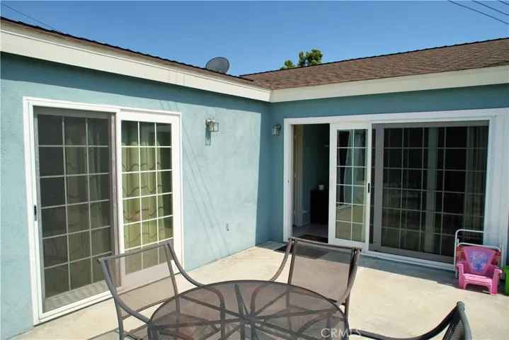 2 backyard doors lead to the paved patio and the grass area,