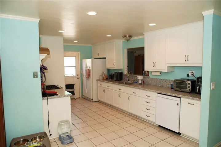lots of storage topped with quartz countertops. matching included dishwasher and refrigerator.