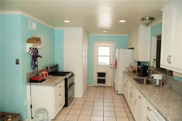 Gas stove is next deep pantry storage.