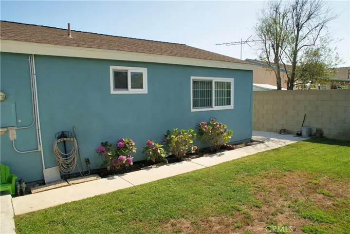 Left view of rear bathroom and bedroom. Walkway to left side yard.