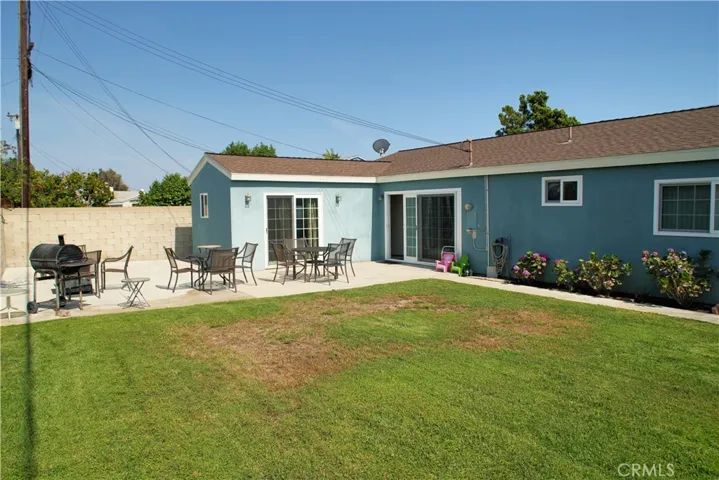 View from left side of backyard, Left side sliding door leads to the primary suite. The right side door leads to the dining area.
