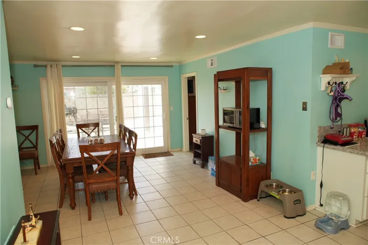 Kitchen to the right dining area straight and primary suite is next to the sliding door