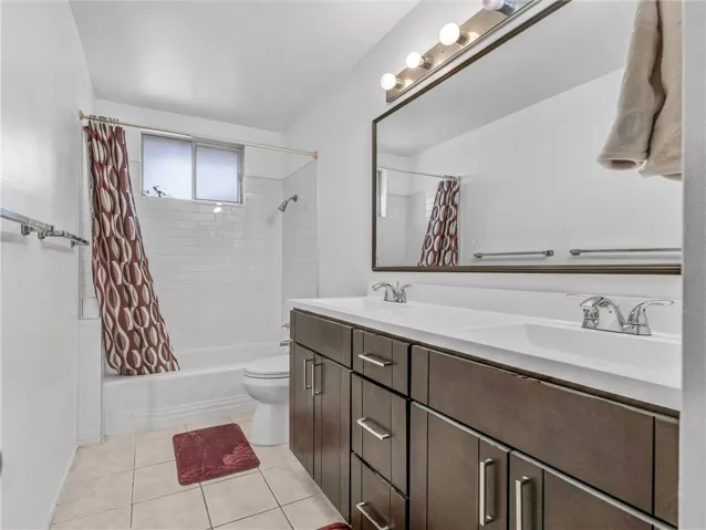 Remodeled guest bathroom with dual vanity + tile surround full bath.