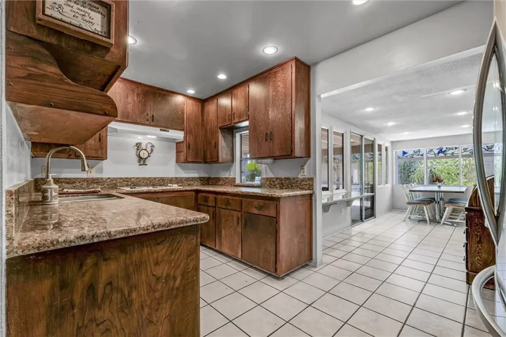 Kitchen offers granite countertops, stainless steel appliances, and recessed lighting.
