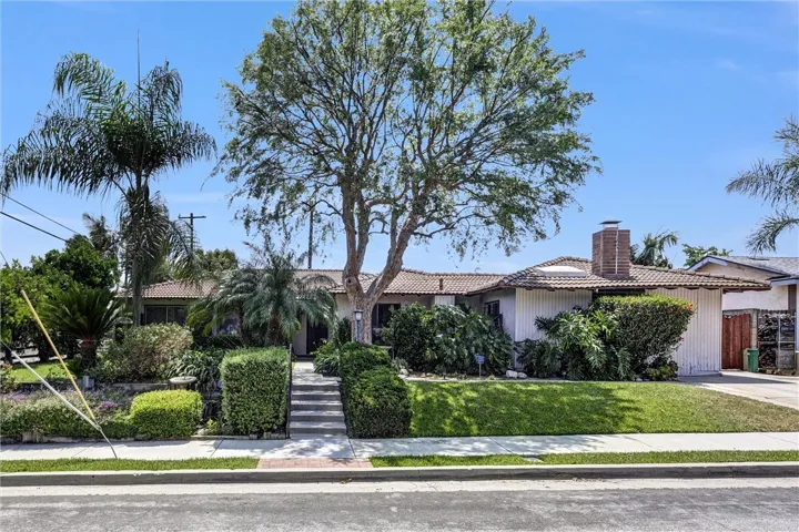 Raised lot with lush landscaping.