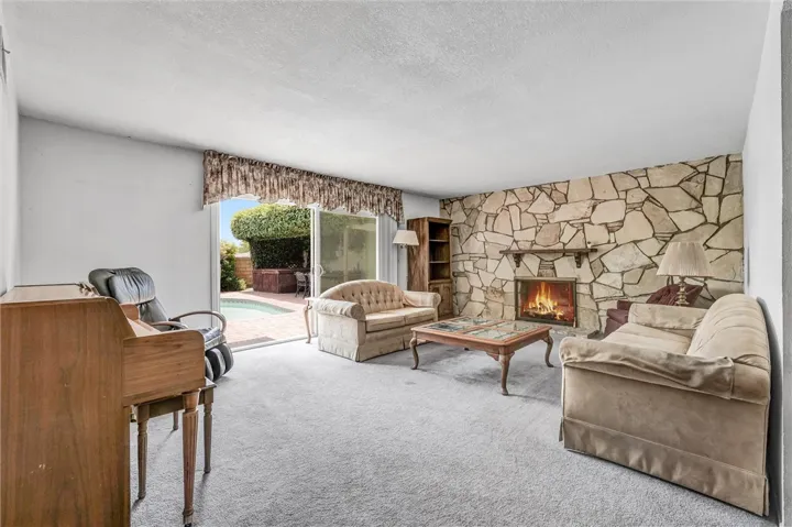Living room with cozy fireplace and direct access to your entertaining backyard.