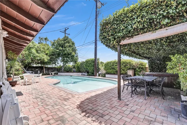 Entertainers' backyard with spacious "paver" patio; pool + lush landscaping!  The backyard sits above the neighbors for ultimate privacy.