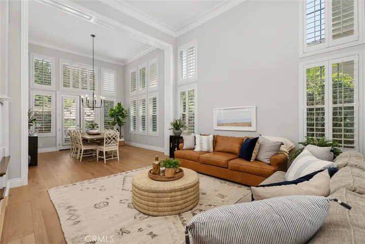 Look at the detail with crown molding on the ceilings & rich real wood plank flooring.