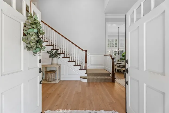 Step inside to warm, rich wood flooring that flows throughout the main living areas, complemented by soaring ceilings and a striking staircase that adds architectural elegance!