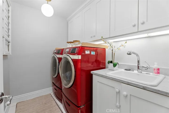 Inside laundry with soaking sink and abundant storage.