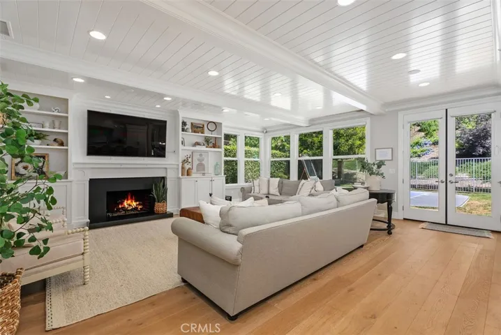Oversized and expanded family room right off kitchen.  Open and bright.  Custom white plank wood ceiling!